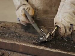 Clean the iron with a hammer and wire brush Stock Footage