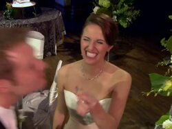 Bride laughing as she stuffs cake in groom's mouth Stock Footage