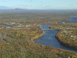 WS AERIAL ZI View of small town and wooded area with autumn color at Howland / Maine, United States Stock Footage