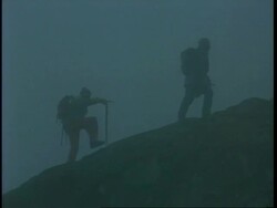 WA team of hikers walking up snowy mountain in thick fog, Rwenzori Mountain, Uganda, Africa Stock Footage