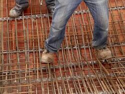 MS Shot of workmen still road tying in metal wire at house construction / Hermeskeil, Rhineland-Palatinate, Germany Stock Footage