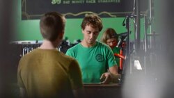 Bike shop employee chats with customer and scrolls on tablet computer Stock Footage