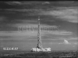 1953: HOLLOMAN AIR FORCE BASE: Men carrying items tower steps, attaching item in rocket, VS Men in Control Center, using console, counting down, CU Male fingers on 'Arming' key, 'Fire' switch, WS Rocket taking off, VS Monitoring rodents vital signs, Instructional Video