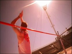 MS man jumping over high jump, bar falling, Australia Stock Footage