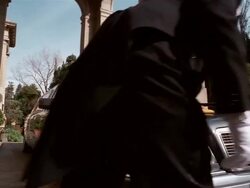 Low angle long shot chauffeur polishing hood of limousine Stock Footage