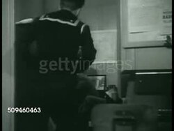 1938: COAST GUARD INVESTIGATION: DRAMATIZATION: Coast Guard Investigators reporting to Stephen S. Yeandle in office. Sailor reading message from Washington to continue investigation for boat ownership. Instructional Video