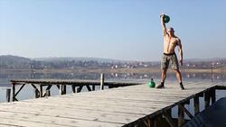 Doing exercise with kettle Stock Footage