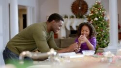 Father and daughter roll up cookie dough into a ball (dolly-shot) Stock Footage