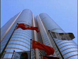 MS Low angle, Flags flying against modern city building, Hong Kong Stock Footage