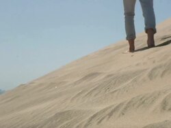MS Boy walking on sand dune / Cape Kiwanda, Oregon, USA Stock Footage