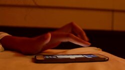 young woman using smart phone on the bed Stock Footage