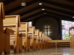 The interior of a church with classic church pews and the cross of Jesus Christ Stock Footage