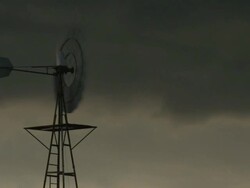 CU Shot of windmill spinning with dark storm clouds / Texas, United States Stock Footage