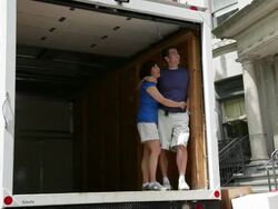 MS Couple looking  out from empty moving truck / Newark, New Jersey, United States Stock Footage