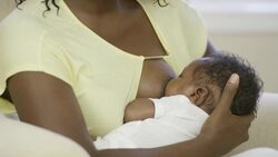 Mother breastfeeding her newborn baby boy Stock Footage