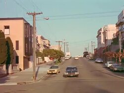 POV driving down hilly city street. Stock Footage