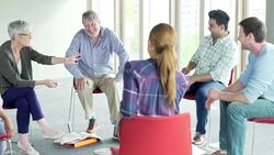 People talking in circle in group meeting Stock Footage