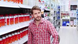 Sales conversation about wall paitn in the hardware store Stock Footage