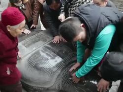 MS Pilgrims touching stone tortoise pray for good luck during Chinese Lunar New Year at Taoist temple / xi'an, shaanxi, china Stock Footage