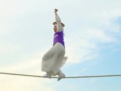 MS PAN Shot of tightrope walker doing acrobatics on high wire / Gyeonggido, South Korea Stock Footage