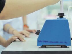 Medical students take the test tube in a shaker Stock Footage
