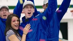 Race-car driver holds up trophy, blue racing team celebrates stock car victory Stock Footage