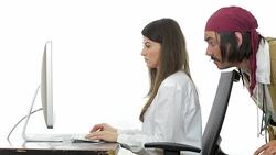 Young woman working while she is being peeked by a pirate. Stock Footage