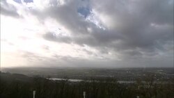 Storm clouds gather over a wooded river. Stock Footage
