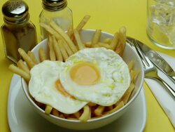 CU Hand serving Fried Eggs & Chips Stock Footage