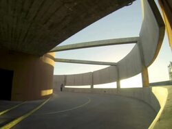 A young man skateboarding down a spiral ramp in a parking garage. Stock Footage