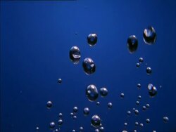 High Speed Water Droplets against blue background Stock Footage