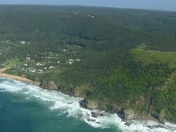WS AERIAL ZI View of paragliding over tree covered mountain / Stanwell Park, Sydney New South Wales, Australia Stock Footage