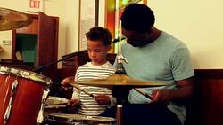 MS Father teaching young son to play drums Stock Footage