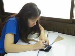 side view Thai woman use talking dictionary for reading. Stock Footage