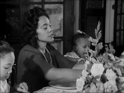 1964 medium shot Coretta Scott King at dinner table Stock Footage