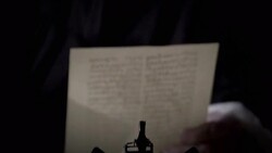 Nostradamus reads a piece of parchment at his desk. Stock Footage