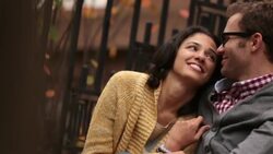 New York couple gaze up at autumn sky; young man kisses girlfriend, girl leans in to nuzzle his cheek (dolly-shot) Stock Footage