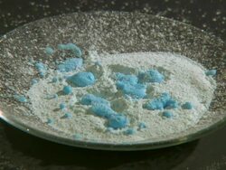 Hydrating anhydrous copper (II) sulphate (white) by dripping water. Stock Footage