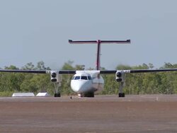 WS TS View of Red and White Passenger Aircraft on Runway Preparing for Takeoff / Truscott, Western Australia, Australia Stock Footage