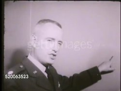 1963: UNITED STATES AIR FORCE ACADEMY: VS Various instructors speaking in their respective classrooms, pointing to panel, globe, chalkboard, speaking w/ cadets in classroom, some raising hands, listening. Fairchild Hall, Colorado, CO, Rampart Range Instructional Video