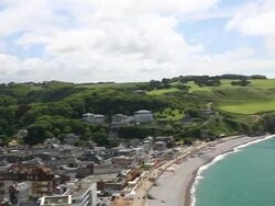 HD panning shot: Etretat village and Aval cliff Normandy, France Stock Footage