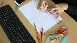 Female drawing house in office Stock Footage