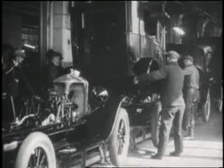 Workers assemble cars in a Ford auto factory. News Clip