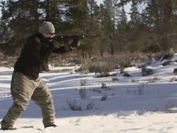 MS SLO MO Shot of man shoots an AR-15 rifle in winter wood landscape / Bend, Oregon, United States  Stock Footage