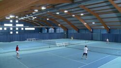 PAN HA WS People Playing Indoor Tennis Stock Footage