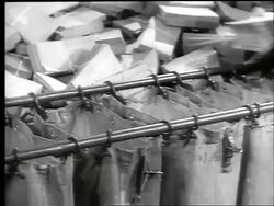 B/W 1944 close up hands of women sorting stacks of envelopes into large mail bags War Bond office / WW II Stock Footage
