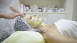 young woman getting facial massage Stock Footage