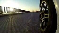 Car driving across country road bridge Stock Footage