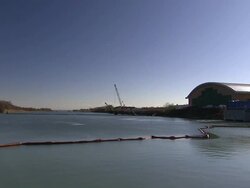 Pipes stretch across a lake near a water treatment plant. Stock Footage