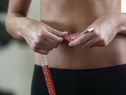 HD DOLLY: Woman Measuring Her Waist Stock Footage